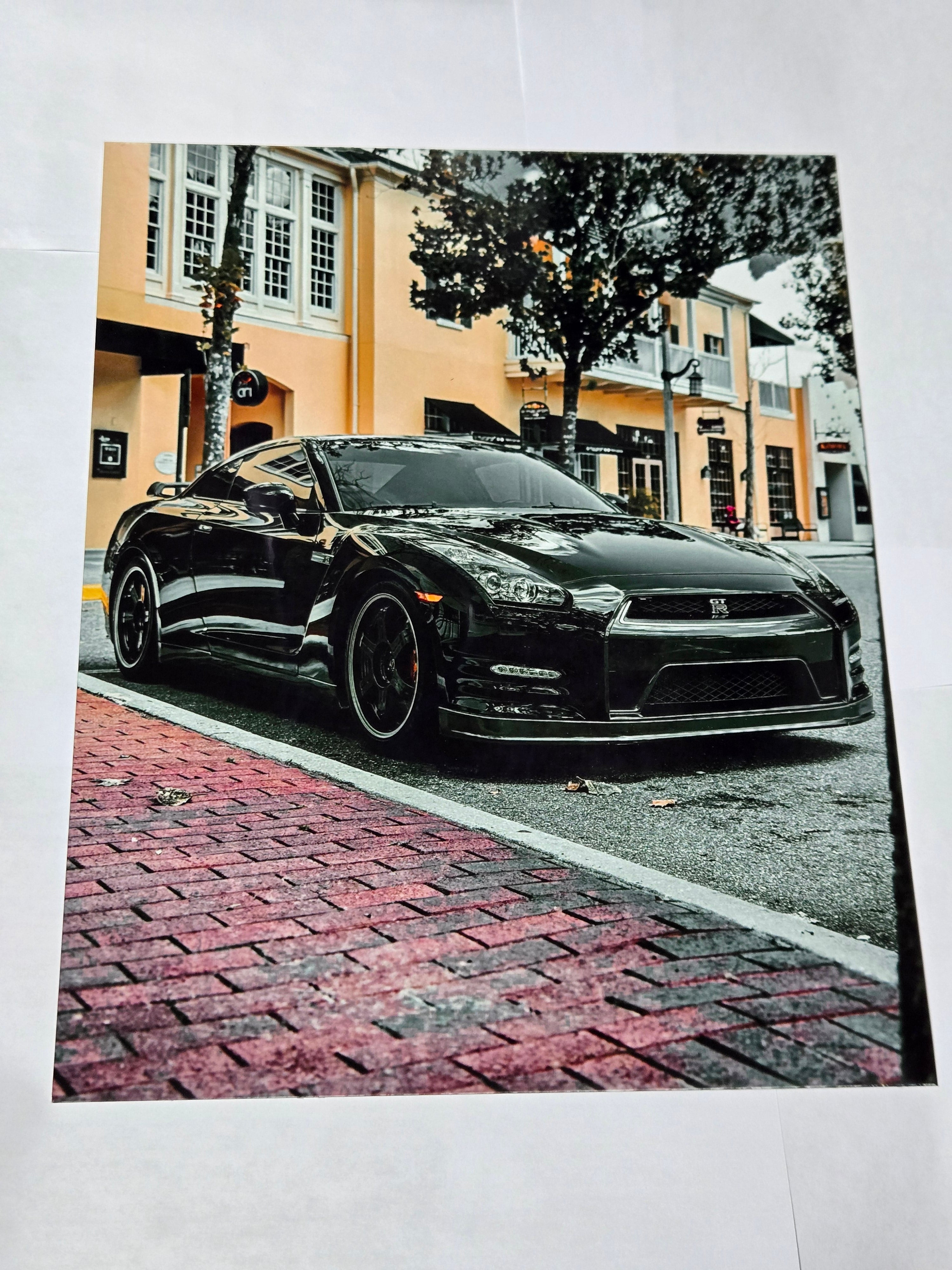 8 by 10 glossy aluminum print of a black car parked on a street with a building in the background