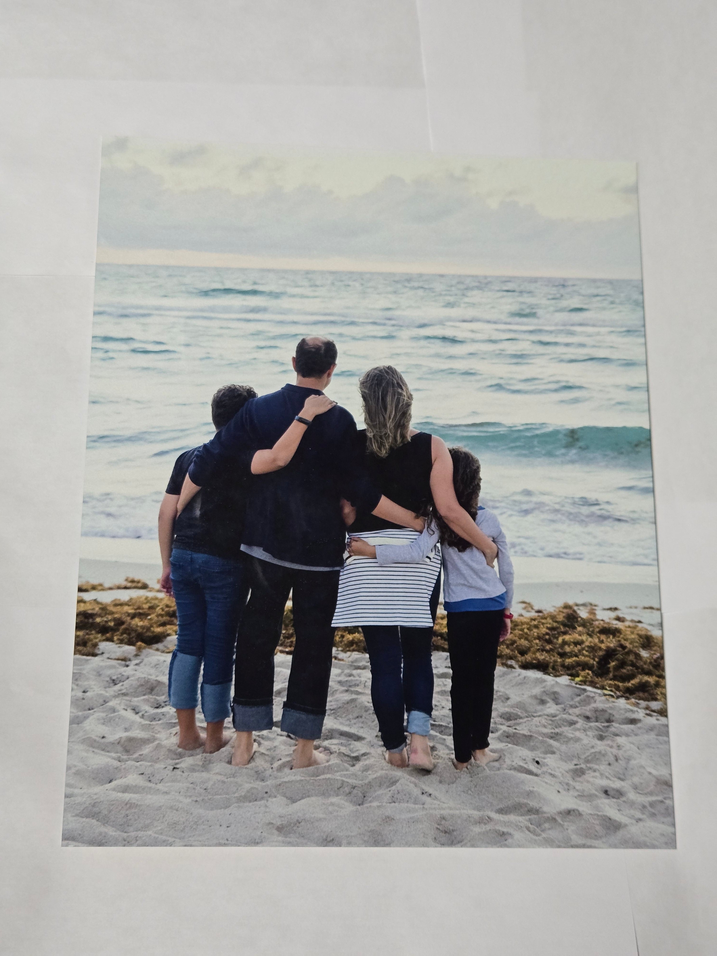 8 by 10 glossy aluminum print of a family photo of four people on a beach.