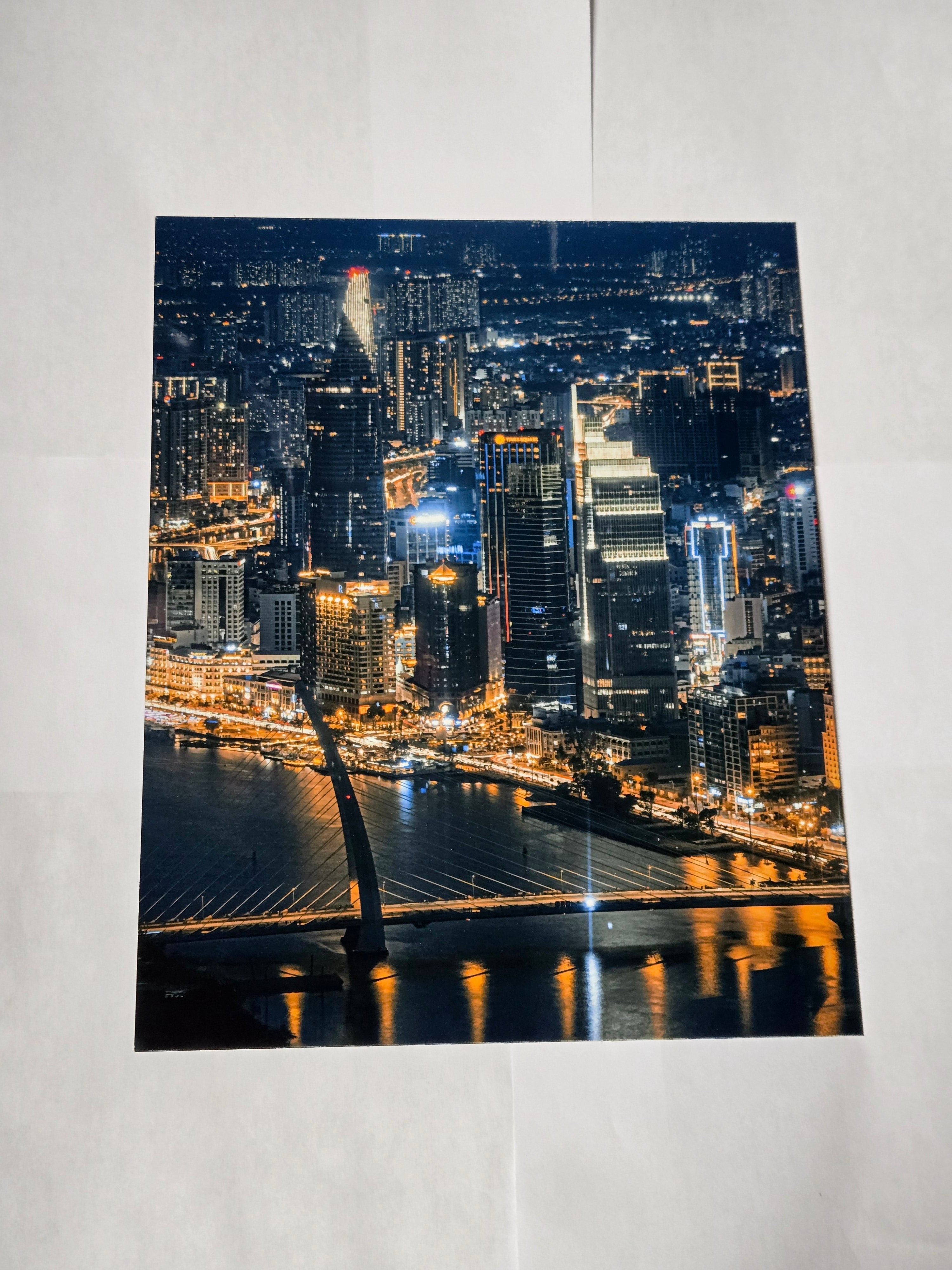 8 by 10 glossy aluminum print of a cityscape at night with illuminated buildings and a bridge.